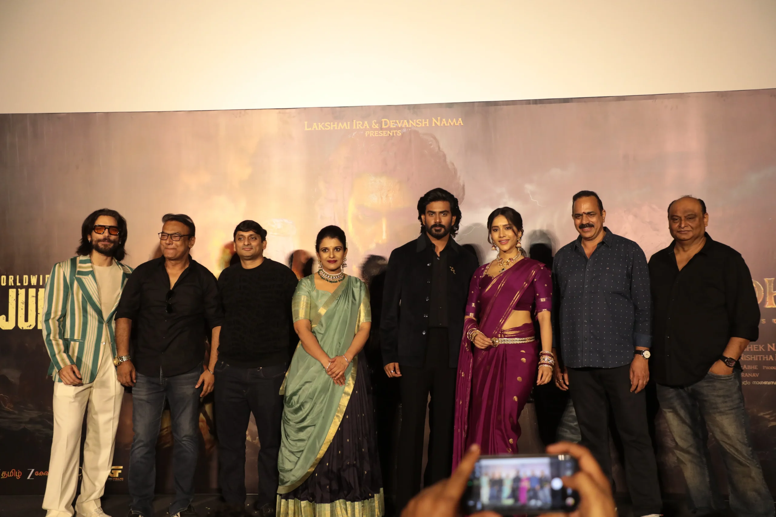 Cast and creators on stage at a film song launch event