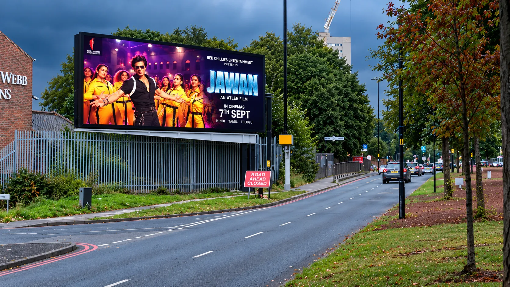 Large digital roadside advertising screens above a London traffic route